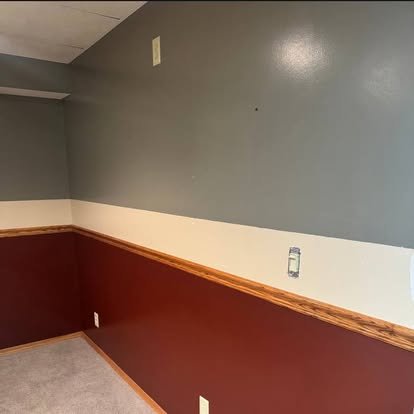 Interior painting with wainscoting trim — two-tone wall finish with stained wood cap rail detail